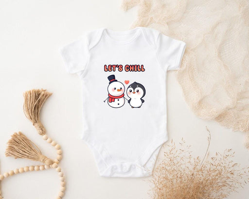 a baby bodysuit with a penguin and a snowman on it