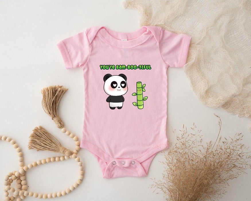 a baby bodysuit with a panda holding a bamboo stick