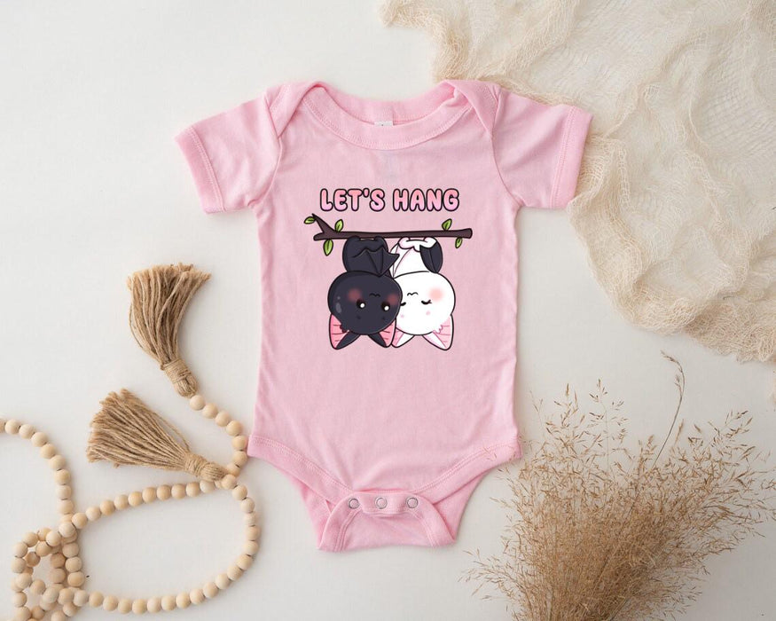 a baby bodysuit with a picture of a dog hanging on a clothes line