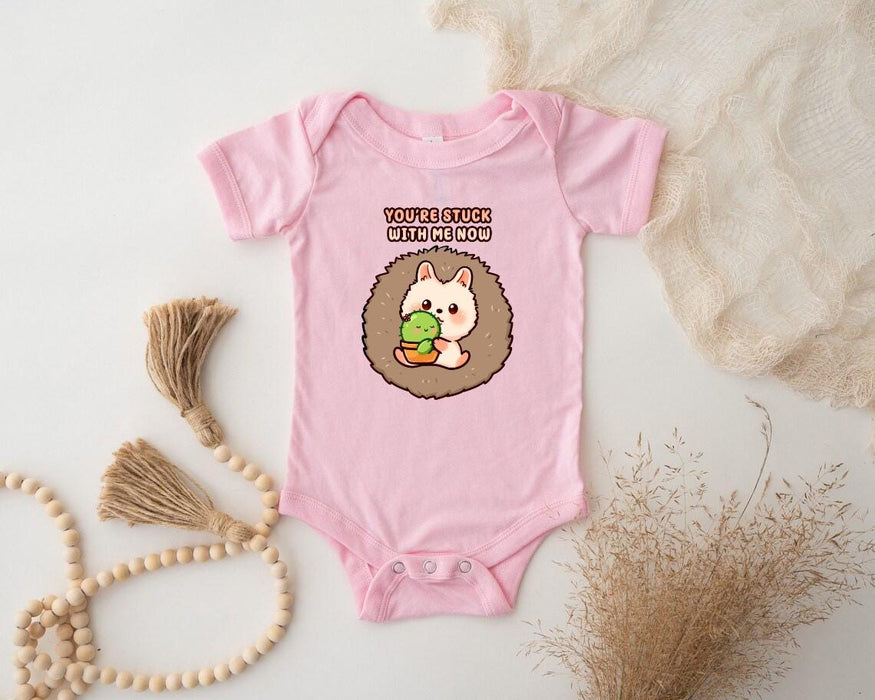 a baby bodysuit with a hedge holding a leaf