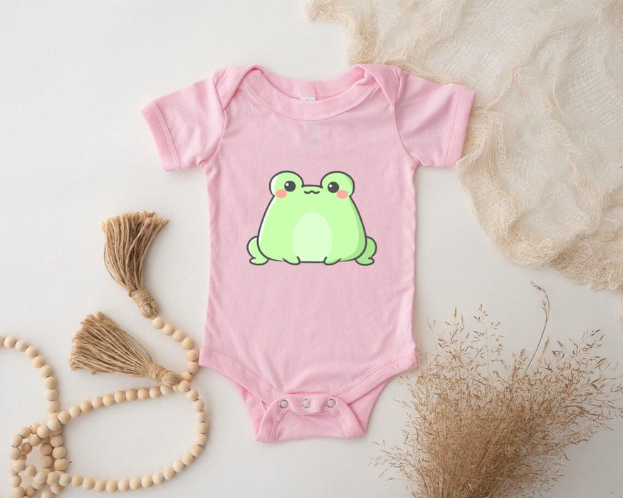 a pink bodysuit with a green frog on it
