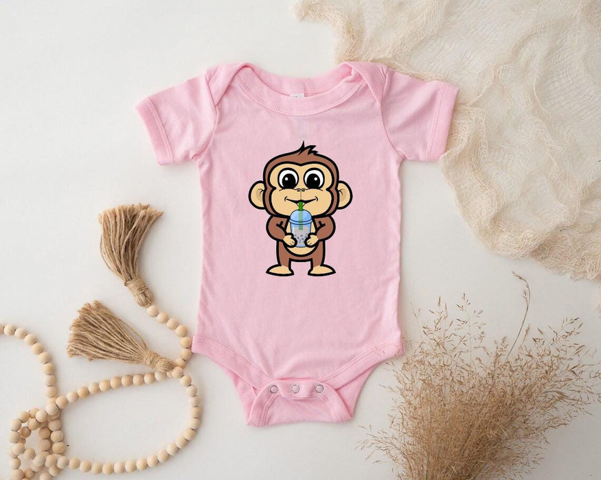 a pink baby bodysuit with a cartoon monkey on it