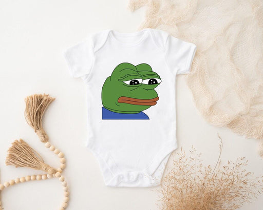 a baby bodysuit with a picture of a frog on it