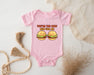 a baby bodysuit with two hamburgers on it