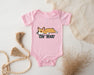 a pink baby bodysuit with a cartoon corgi on it