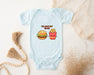 a baby bodysuit with a hamburger and fries on it