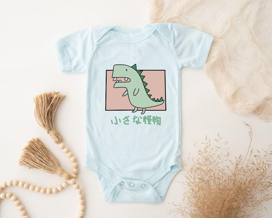 a baby bodysuit with a green dinosaur on it