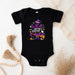 a black bodysuit with a witch saying on it