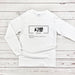 a white long - sleeved shirt with chinese writing on it