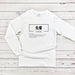 a white long - sleeved shirt with chinese characters on it