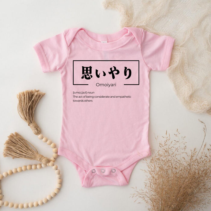 a pink baby bodysuit with japanese characters on it