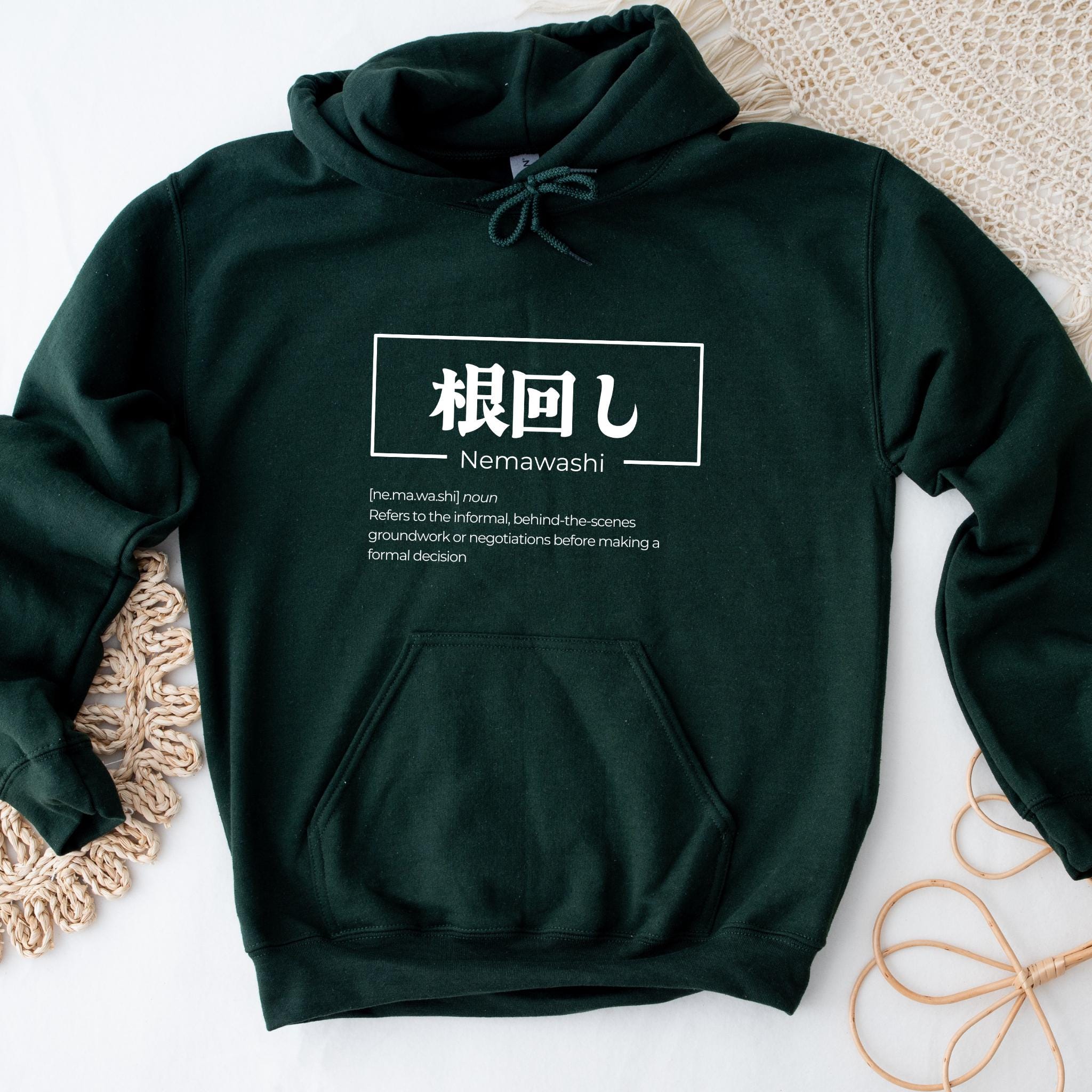 a green hoodie with an asian writing on it