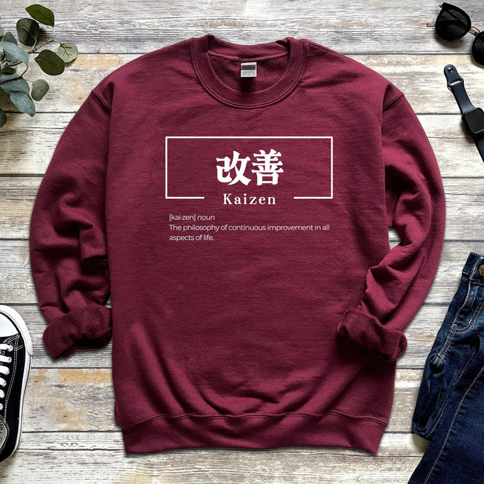 a red sweater with the words kaizen on it