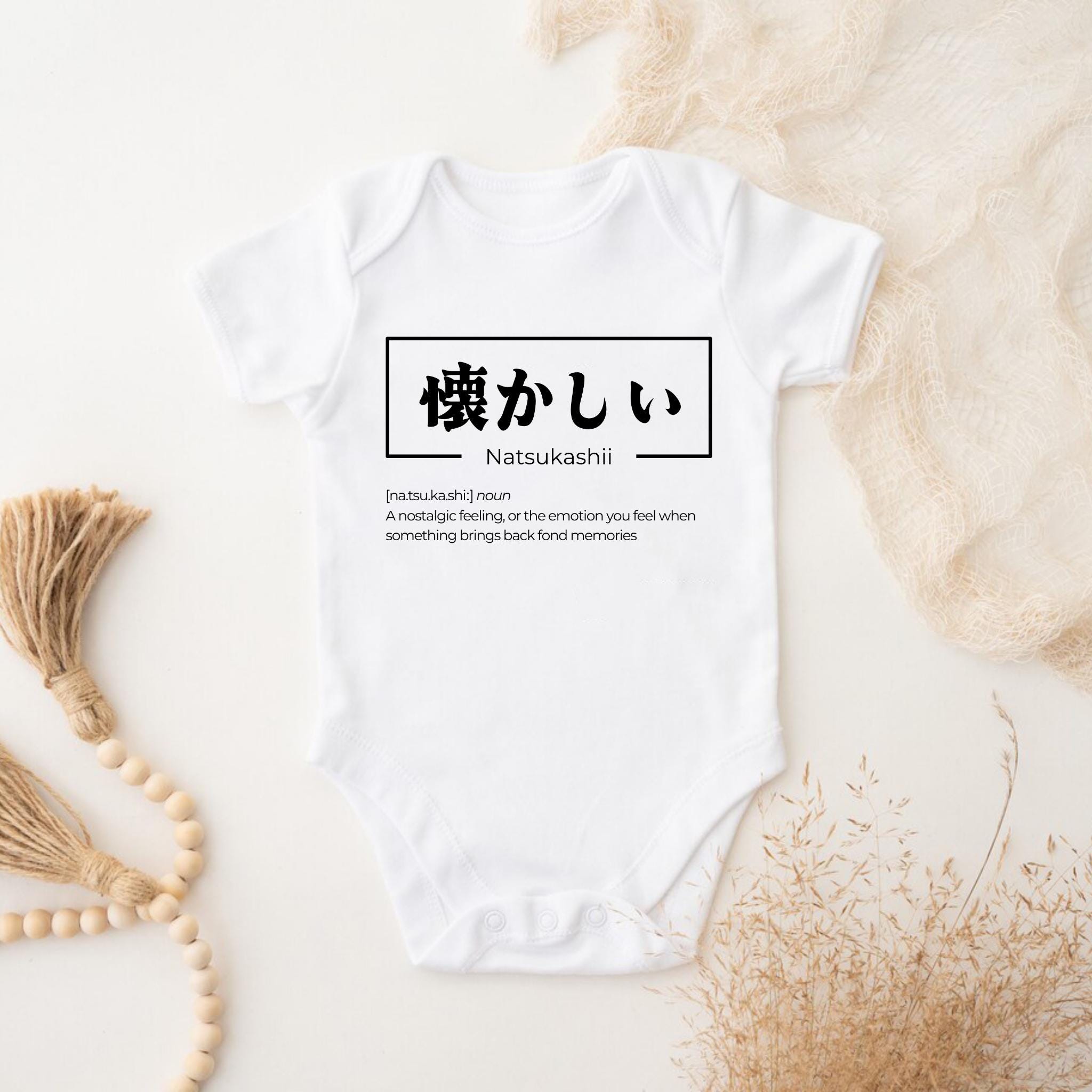 a baby bodysuit with japanese characters on it