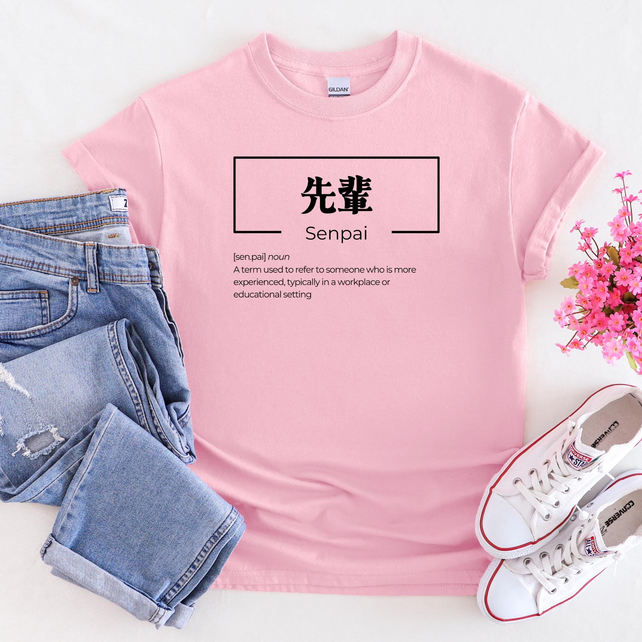 a pink t - shirt with japanese writing on it