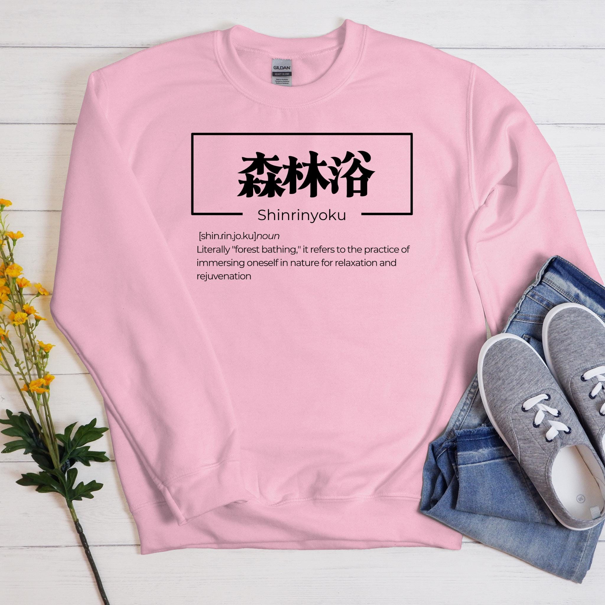 a pink sweatshirt with the words shinnjuju written on it