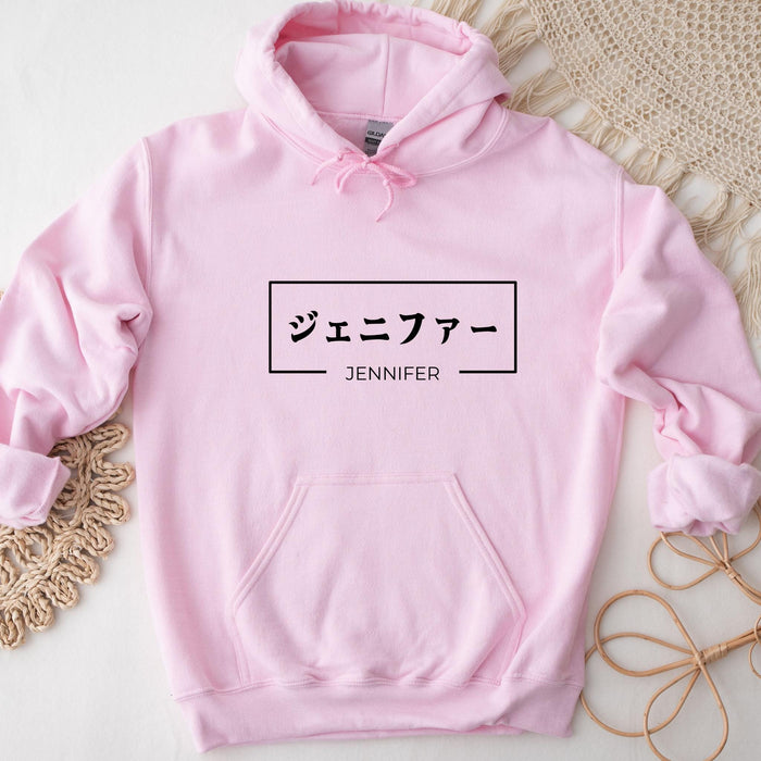 a pink hoodie with japanese characters on it