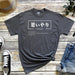 a t - shirt with a japanese writing on it next to a pair of jeans