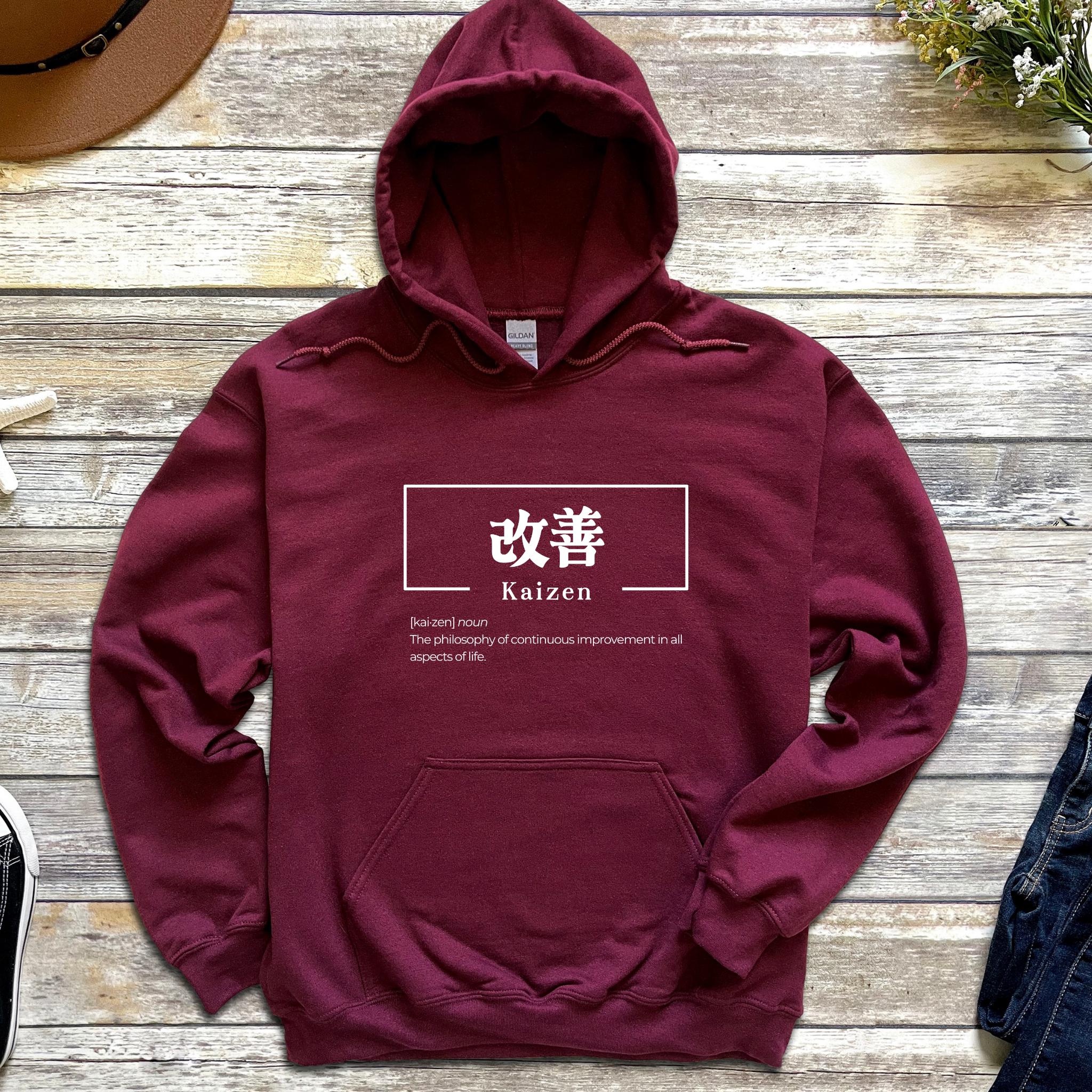 a maroon hoodie with a japanese symbol on it
