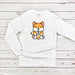 a white shirt with a cartoon fox holding a drink