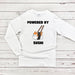 a white long sleeved shirt with a picture of a cat holding a sushi