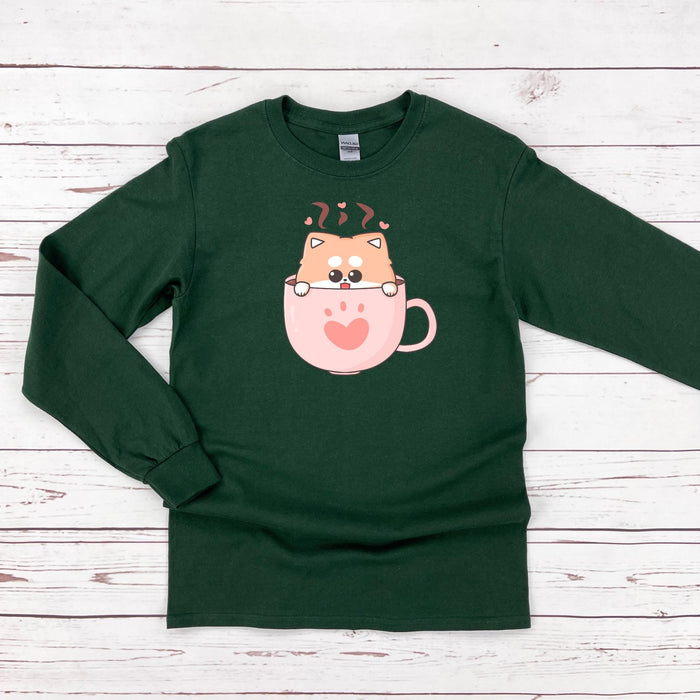 a green shirt with a cat in a cup on it