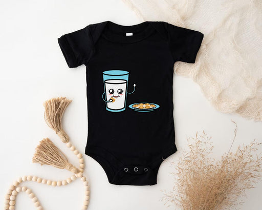 a baby bodysuit with a cup of coffee and a bowl of cereal