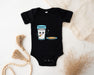 a baby bodysuit with a cup of coffee and a bowl of cereal