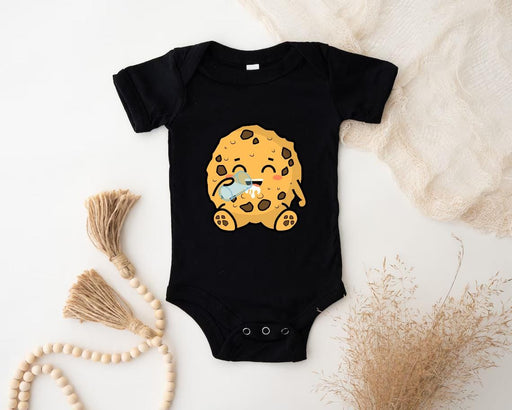 a baby bodysuit with a cookie on it