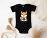 a baby bodysuit with a picture of a dog holding a drink