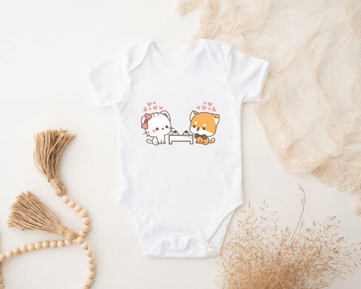 a baby bodysuit with a picture of a cat and a dog on it