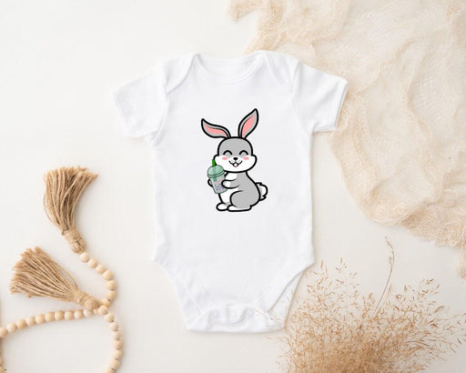 a white bodysuit with a cartoon bunny holding a carrot