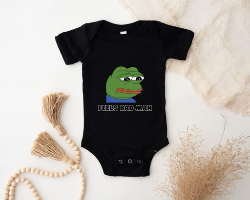 a baby bodysuit with a picture of a frog on it