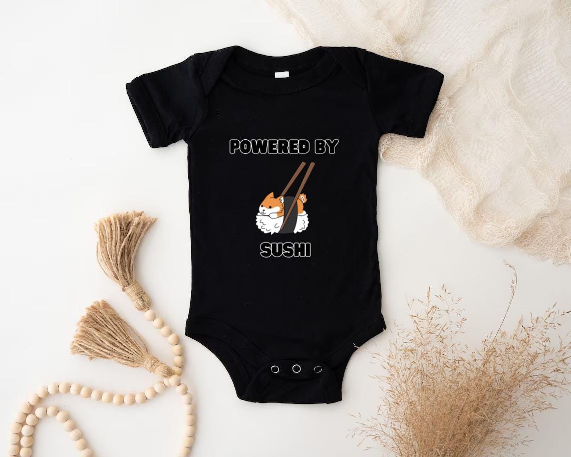 a baby bodysuit that says powered by sushi