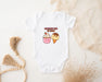 a baby bodysuit with a cupcake and a donut on it