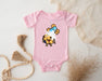 a baby bodysuit with a picture of a teddy bear wearing a party hat