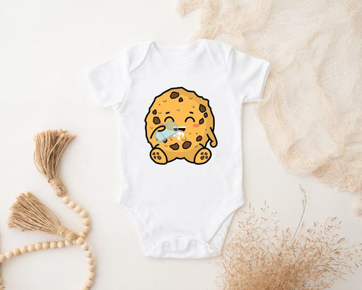 a baby bodysuit with a cookie on it