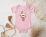 a pink baby bodysuit with a slotty on it
