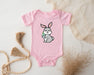 a baby bodysuit with a cartoon bunny holding a carrot