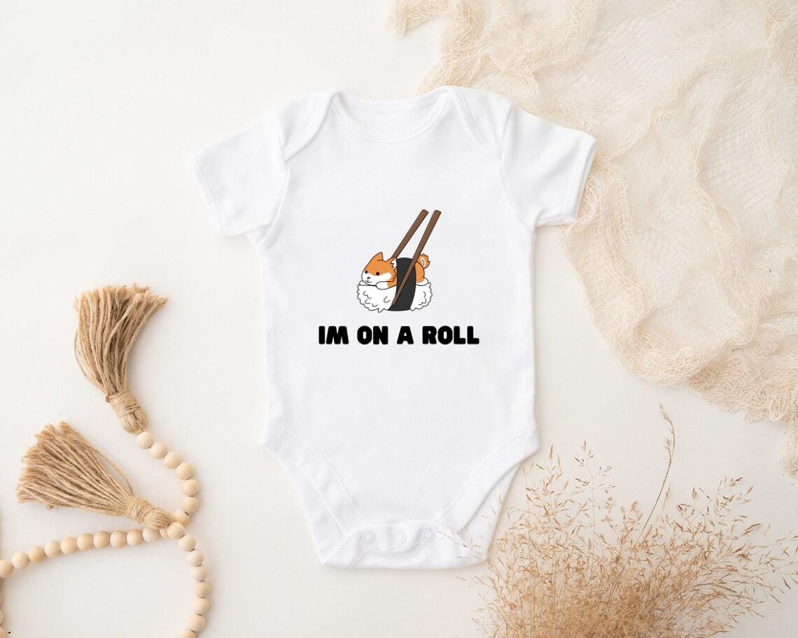 a baby bodysuit that says i'm on a roll with a sushi