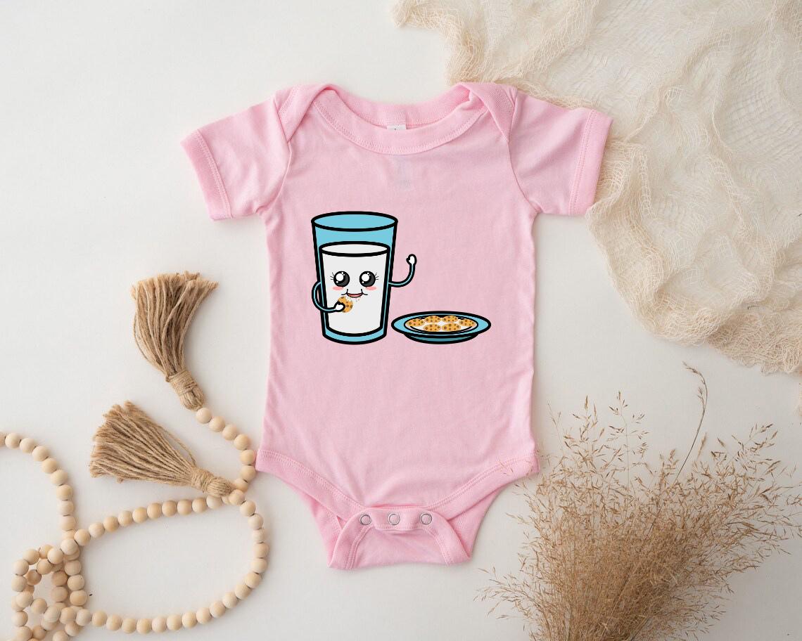 a baby bodysuit with a picture of a glass of milk and a plate of