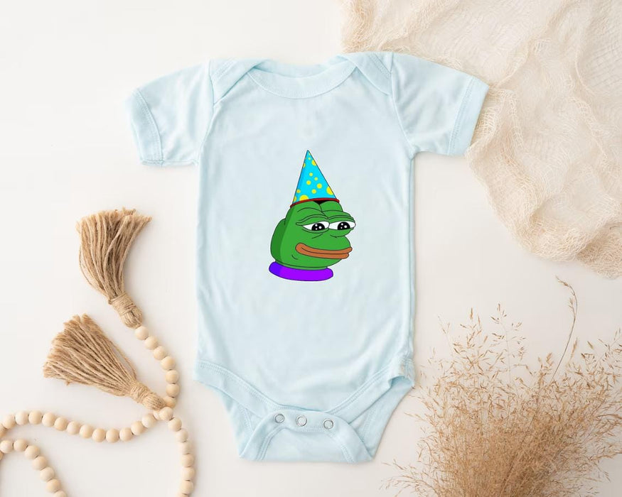 a baby bodysuit with a frog wearing a party hat