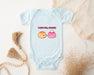 a baby bodysuit with two donuts on it
