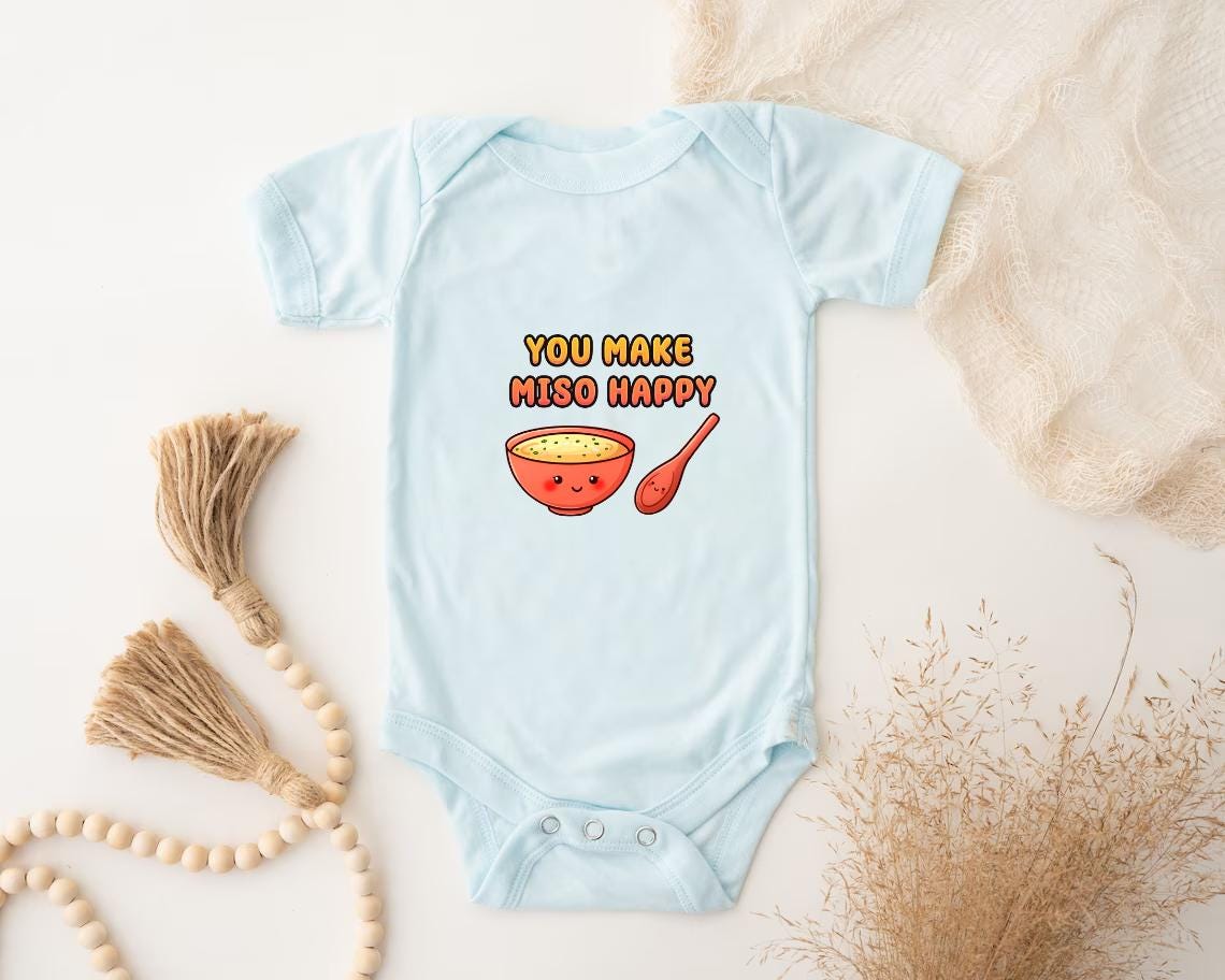 a baby bodysuit with a bowl of cereal on it