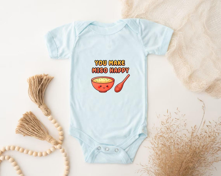 a baby bodysuit with a bowl of cereal on it