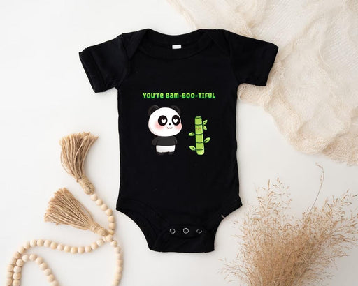 a baby bodysuit with a panda holding a cactus