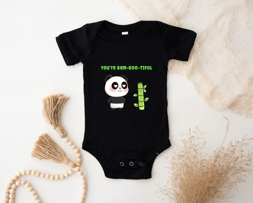 a baby bodysuit with a panda holding a cactus