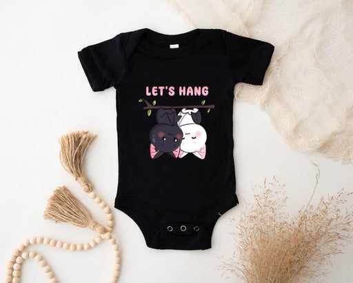 a baby bodysuit with a picture of a dog and a cat on it