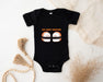 a baby bodysuit with two slots on it