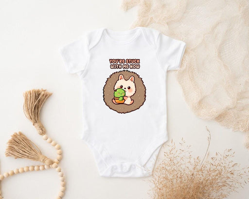 a baby bodysuit with a hedge holding a leaf